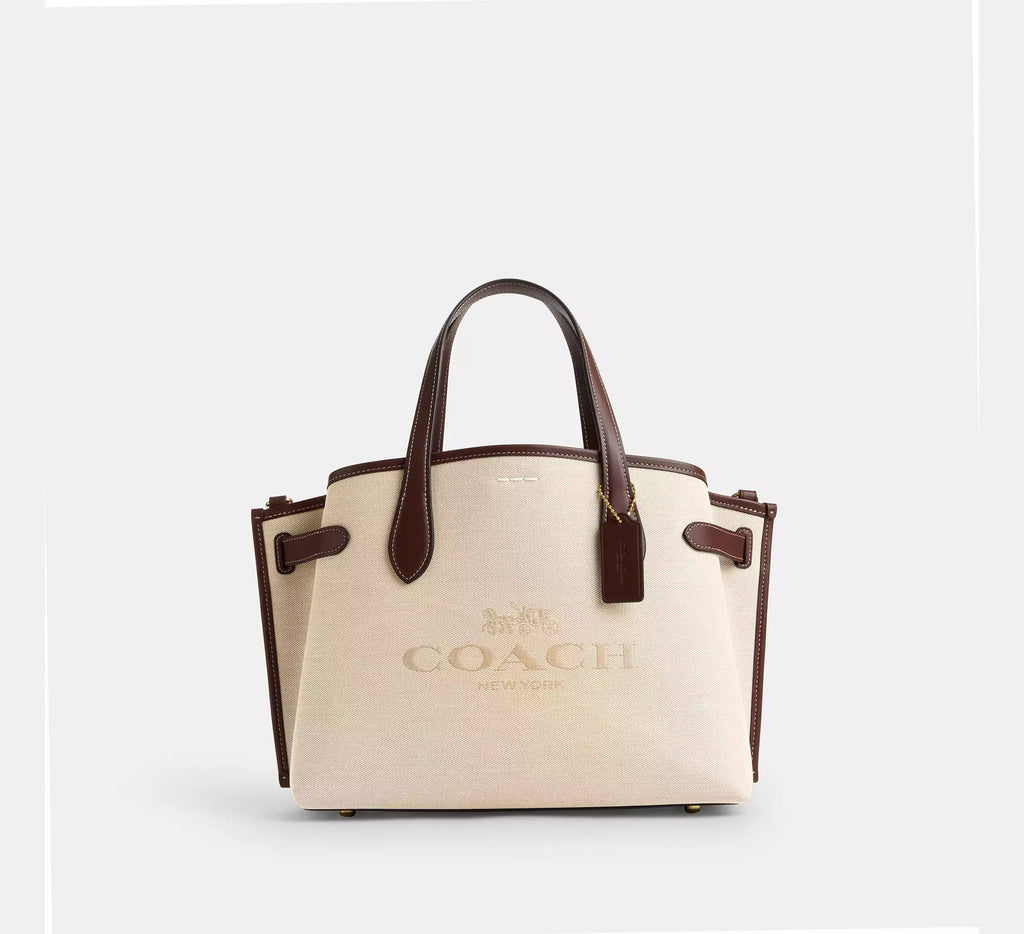Coach Hanover Tote, ivory canvas with brown leather trim and Coach New York horse-and-carriage logo, front view