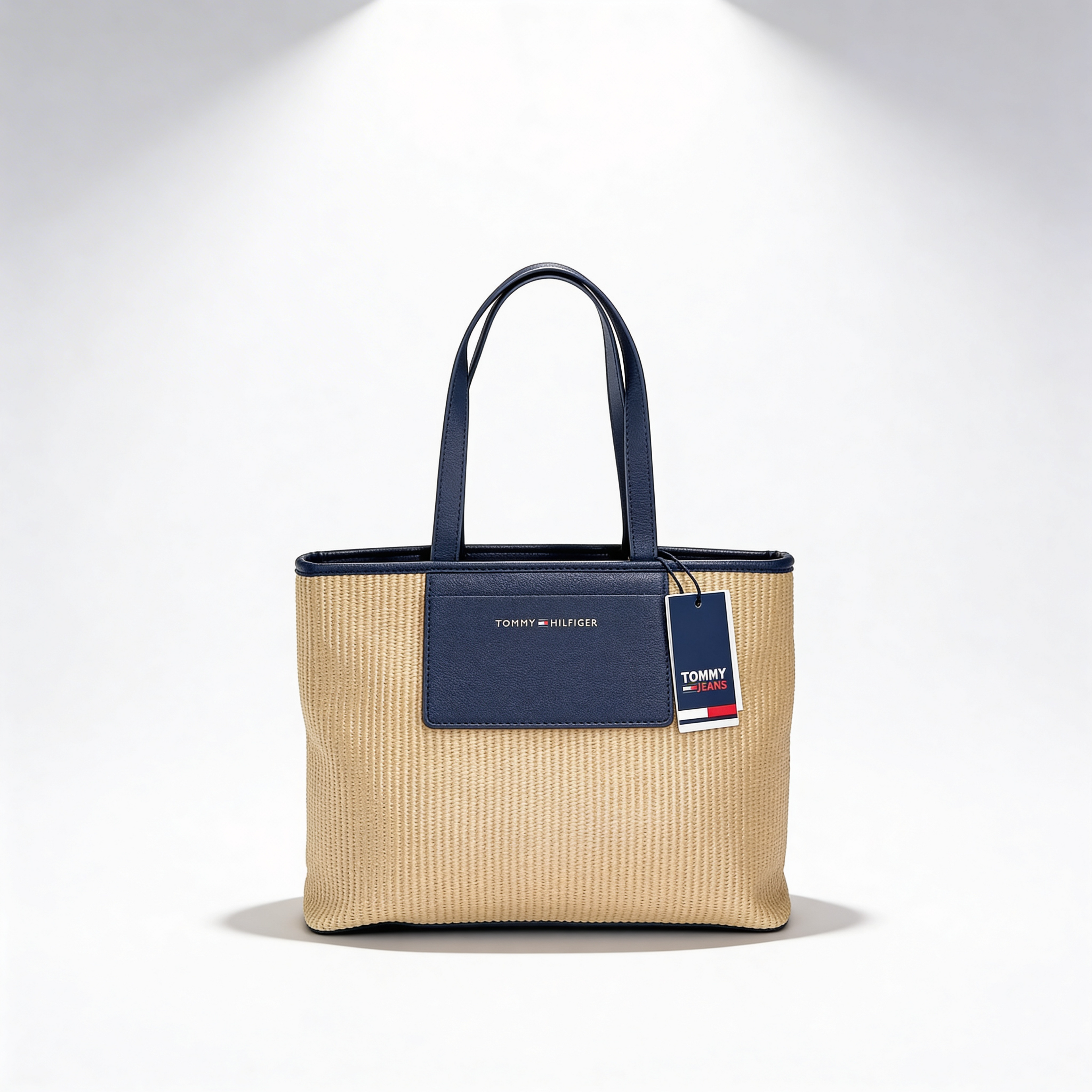 Tommy Hilfiger Iconic Tote, natural canvas, side angle with navy leather handles