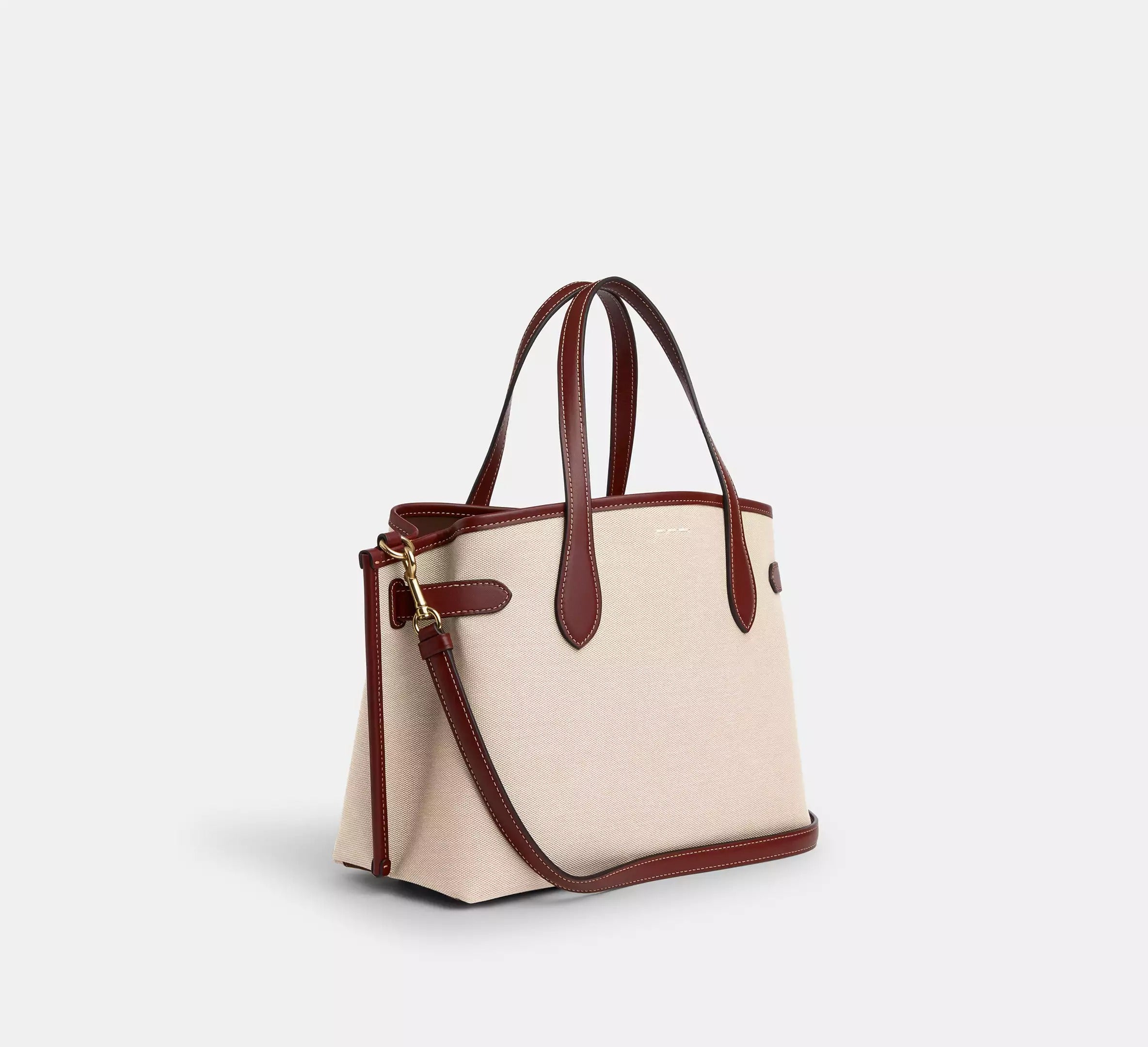 Coach Hanover Tote, ivory canvas with brown leather, side angle on pure-white