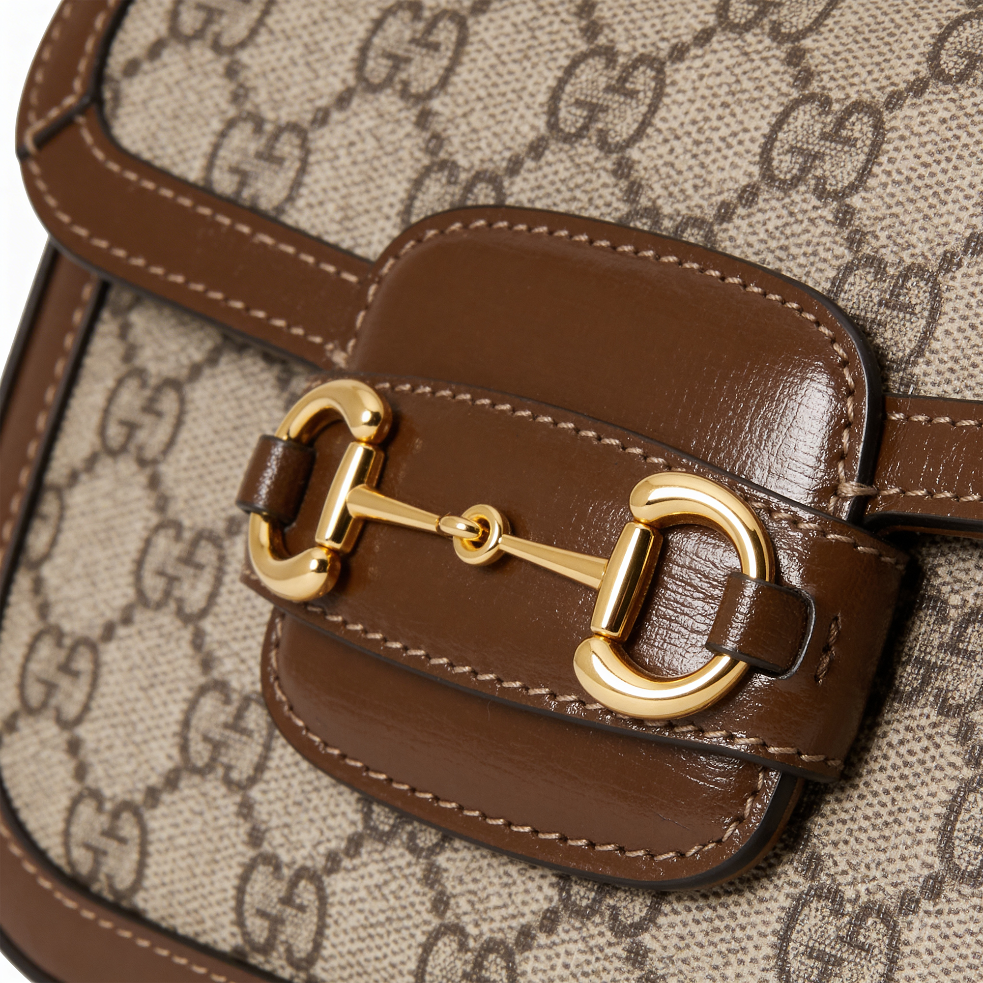 Gucci 1955 Horsebit Shoulder Bag, close-up of gold horsebit hardware on brown leather
