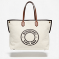Burberry England Logo Tote, natural canvas with tan leather trim and circular BURBERRY ENGLAND logo, front view