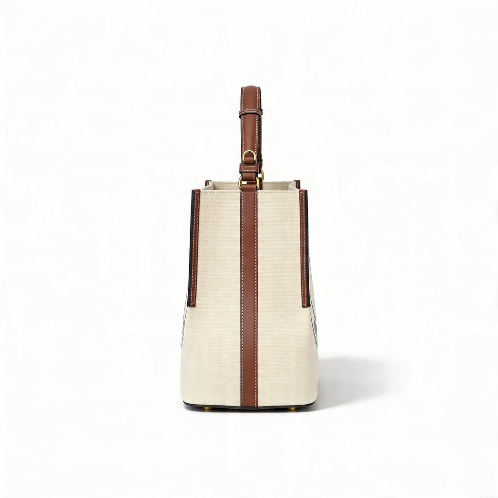 Burberry Logo Graphic Small Canvas Tote, side profile showing vertical tan leather strap and adjustable top handle