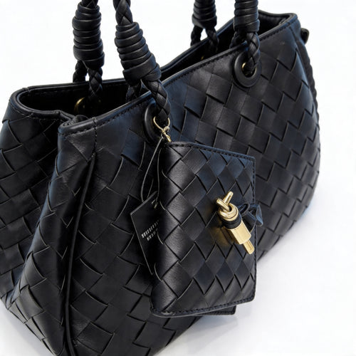 Bottega Veneta Andiamo Mini Tote in black intrecciato leather, close-up showing braided handles and gold-hardware mini pouch with key charm