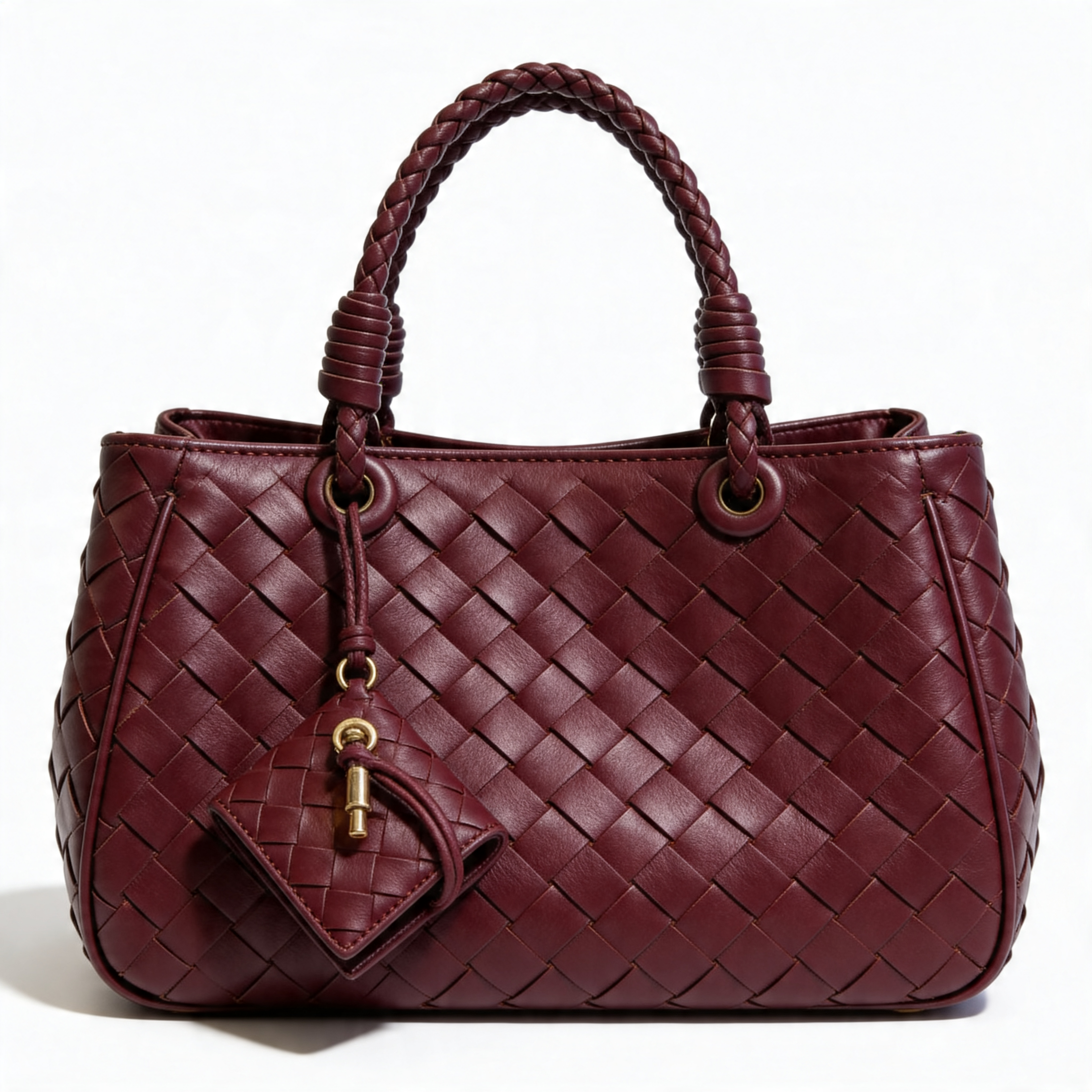 Bottega Veneta Andiamo Mini Tote in bordeaux intrecciato leather, front view with braided handles and matching mini charm