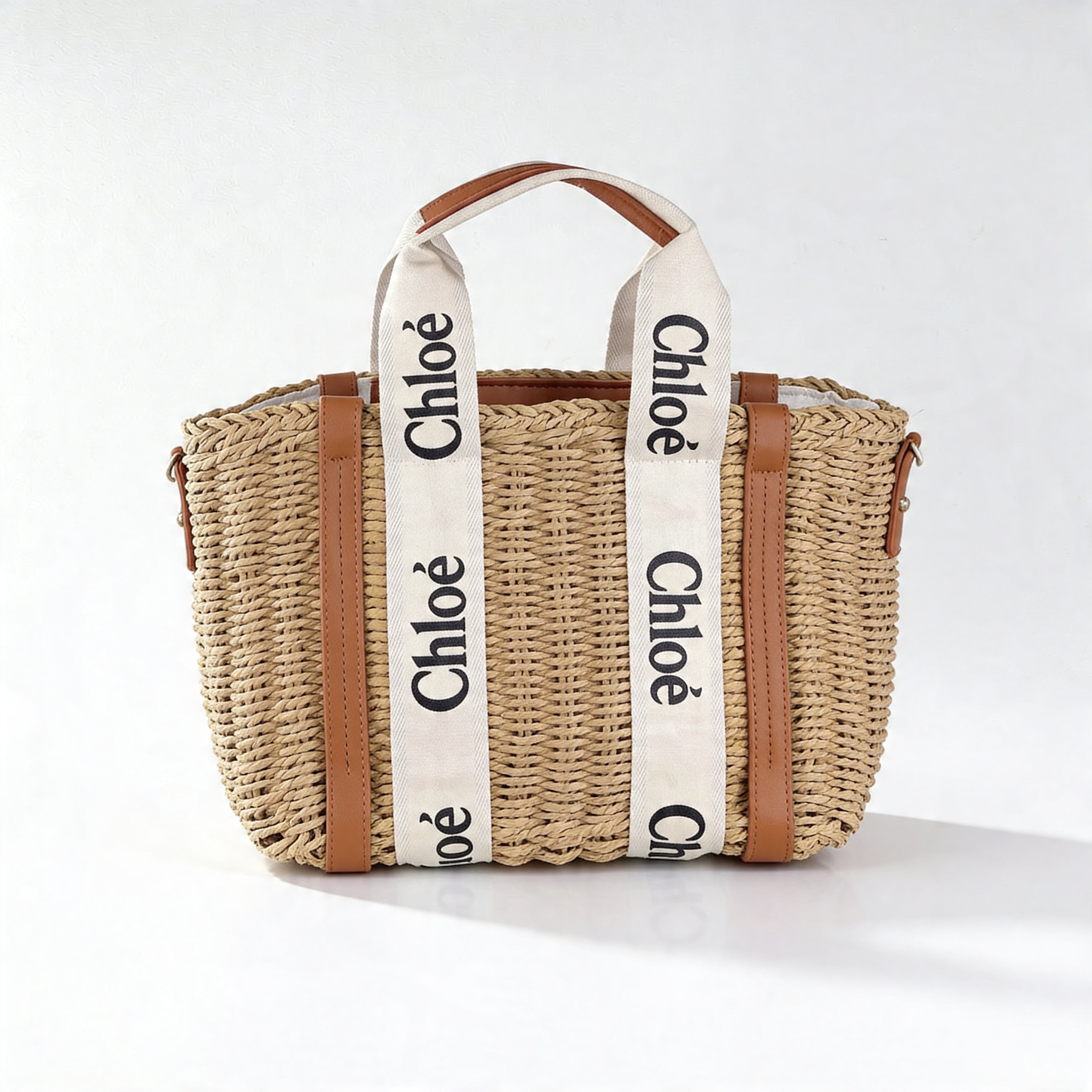 Chloé Woody Basket Tote, front view on off-white, wicker body with ivory Chloé canvas straps and tan leather trim