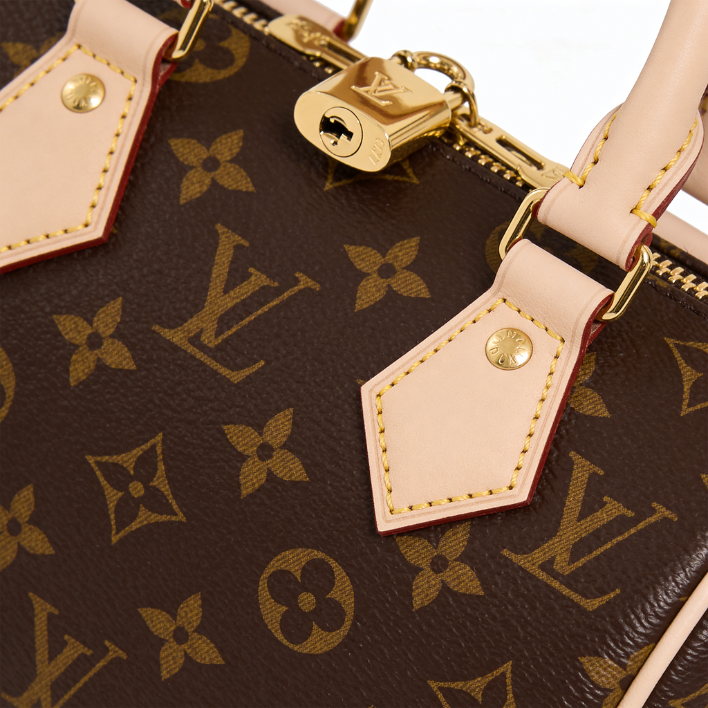 Louis Vuitton Speedy, close-up of brass padlock and vachetta leather pull tab on Monogram canvas