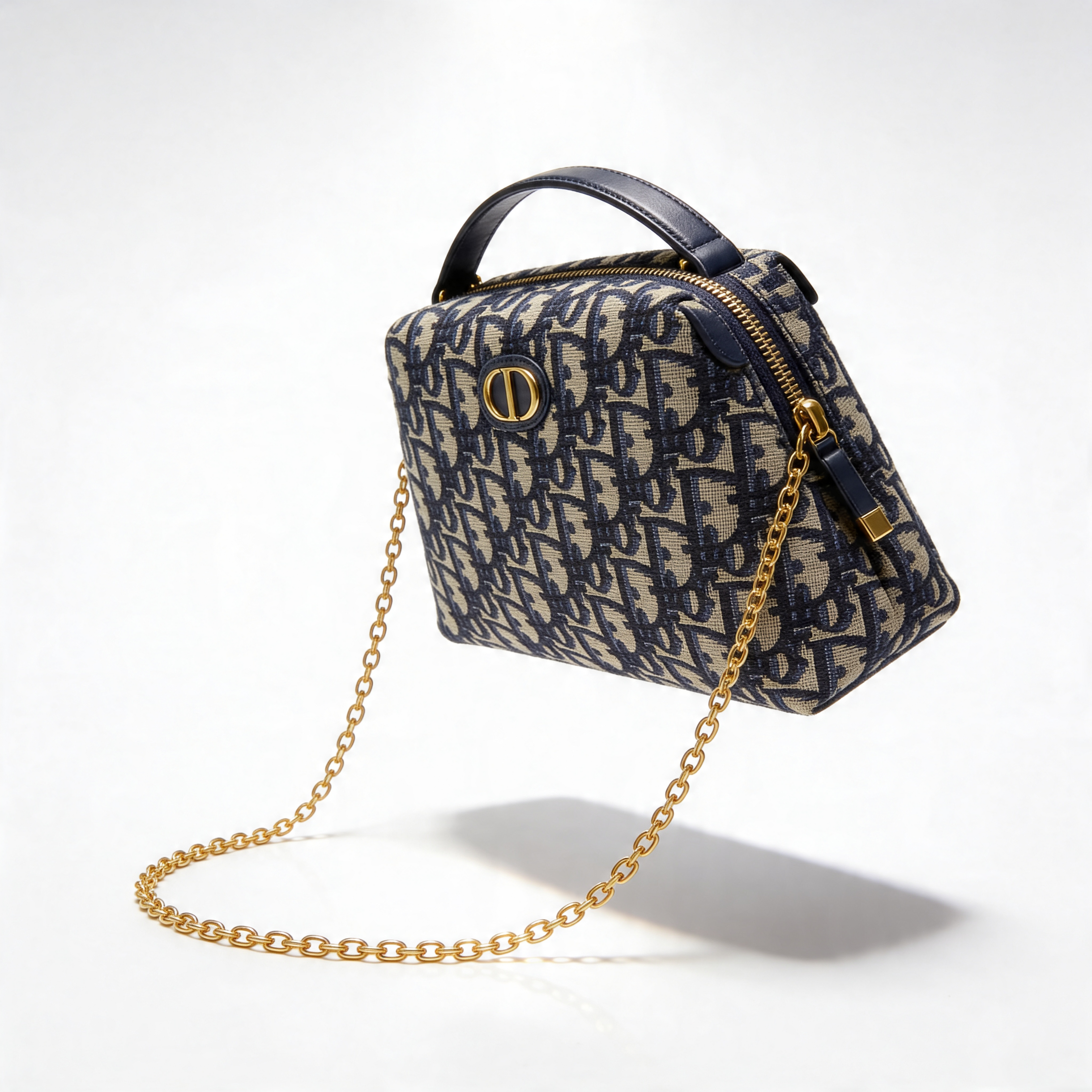 Christian Dior Bobby Bag, navy Oblique canvas, floating 3/4 view with chain strap, off-white background