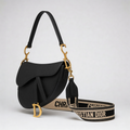 Christian Dior Saddle Bag, black grained leather, gold D charm and embroidered Christian Dior shoulder strap, side angle
